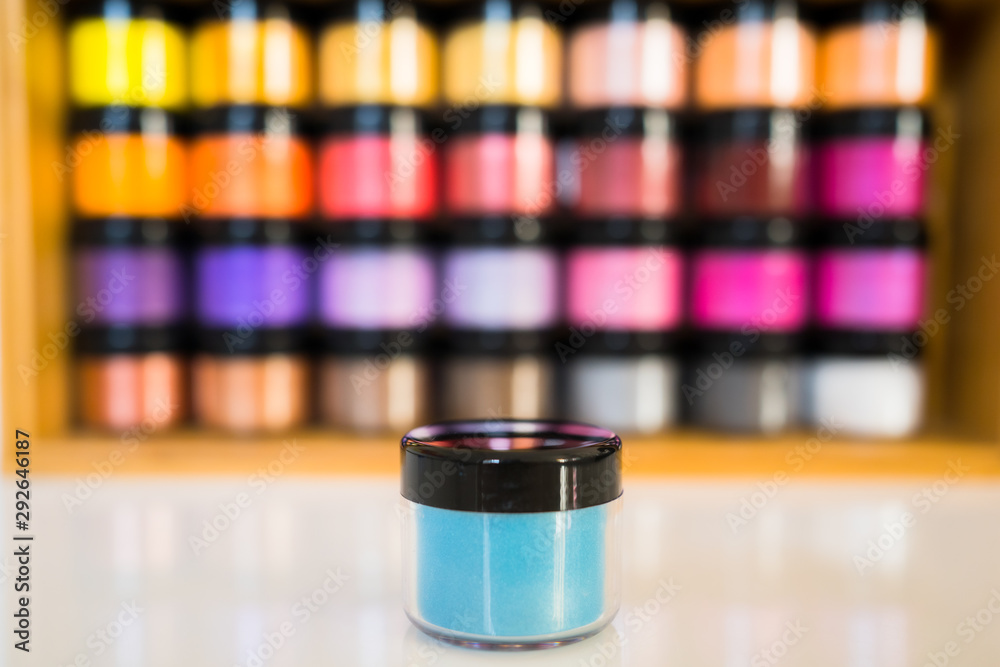 Rainbow color powder in small boxes tins stacked and ordered
