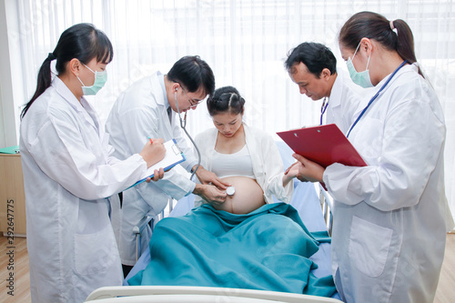 A group of doctors who take care of pregnant women closely to give birth to children safely. Hospital concept  obstetrics department and patient health care