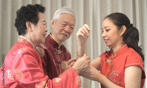 Asian parents give daughter in law gold bracket Chinese New Year