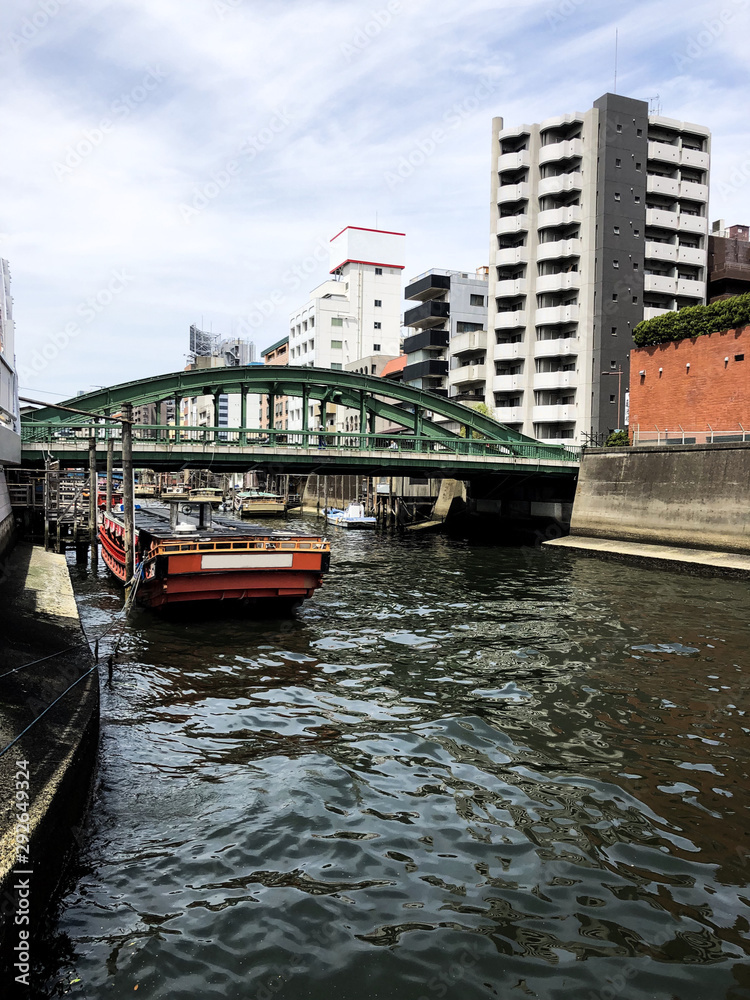 Obraz premium Tokyo port with beautiful old boats and classic buildings on the sumida river