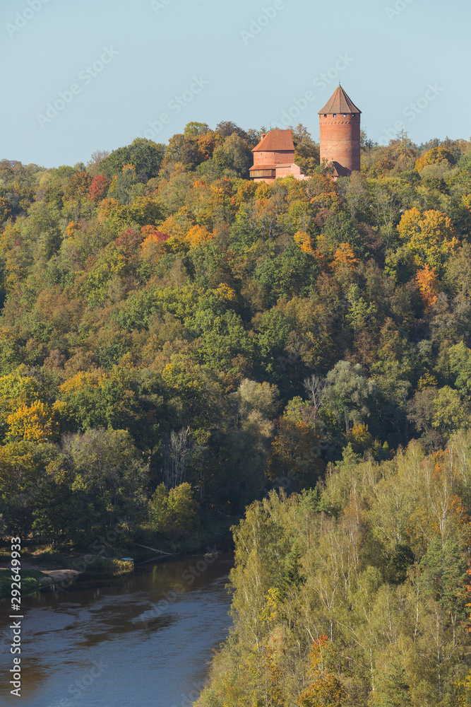 Obraz premium City Sigulda, Latvia Republic. Old castle, build from red bricks. Around trees with yellow leafs. 27. Sep. 2019