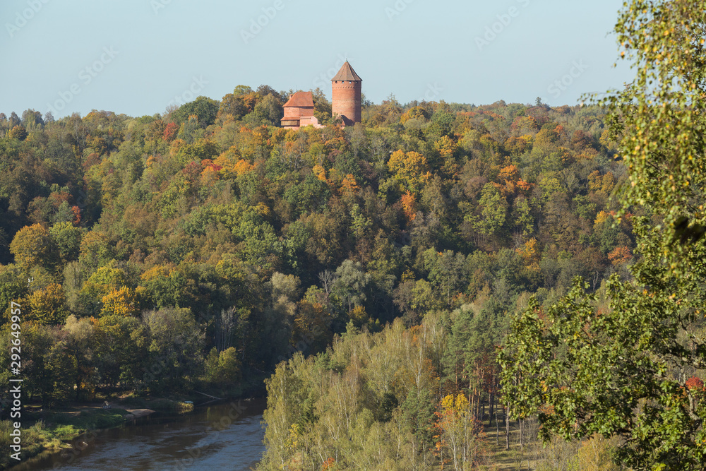 City Sigulda, Latvia Republic. Old castle, build from red bricks. Around trees with yellow leafs. 27. Sep. 2019 City Sigulda, Latvia Republic. Old castle, build from red bricks. Around trees with yellow leafs. 27. Sep. 2019