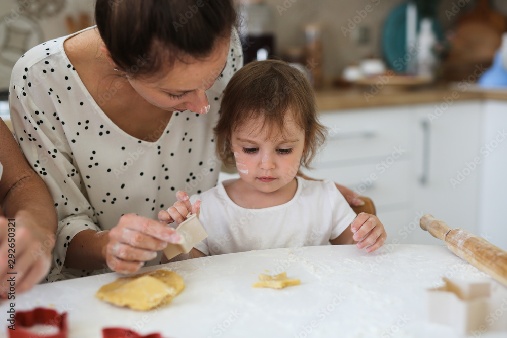 Mom and daughter Toddler together make cookies