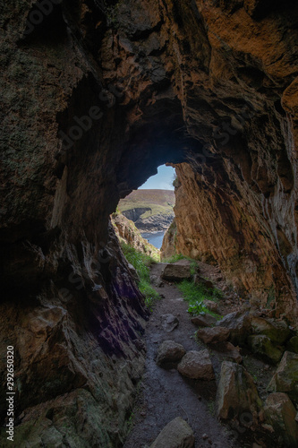 Looking out from inside a cave at Lands End Cornwall on the coast path.