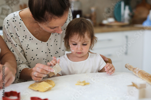 Mom and daughter Toddler together make cookies