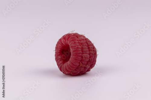 One isolated raspberry without leaf with hole on white background