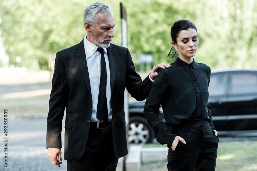 bearded man touching hand of attractive woman with hands in pockets bearded man touching hand of attractive woman with hands in pockets