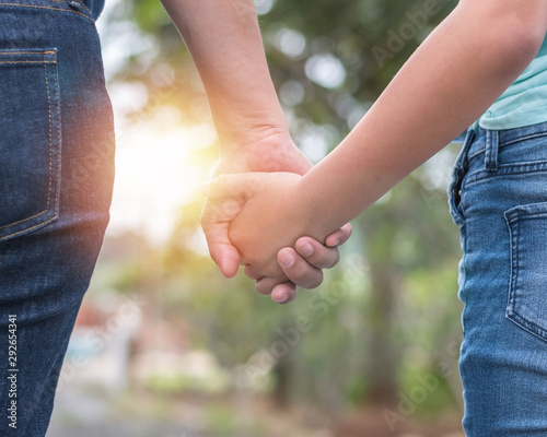 Mother and child teenager girl daughter holding hands for family care support, parenting, teen child safety assurance awareness concept