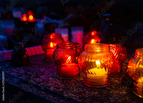 Candles on tombsone - all souls night celebration in Europe - blue hour outdoor shot