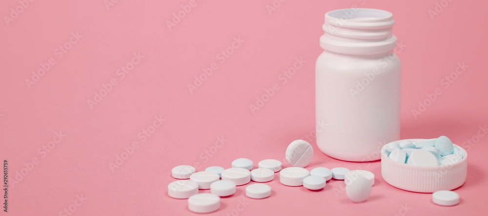 White medical pills on blue background. White medical pills on blue background.