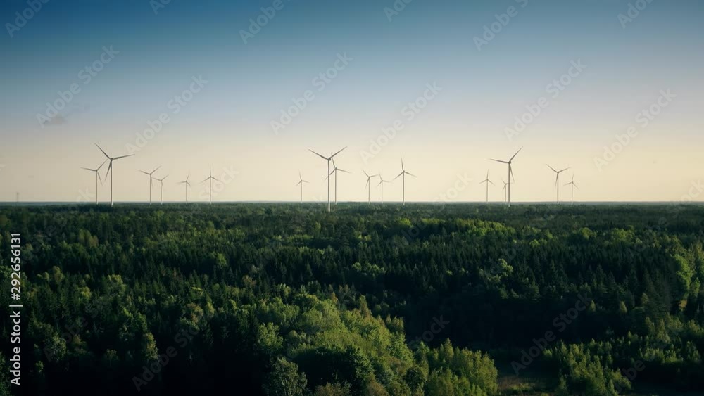 Renewable source of energy power mills amidst greenery in Sweden outskirts, wide grand shot Renewable source of energy power mills amidst greenery in Sweden outskirts, wide grand shot
