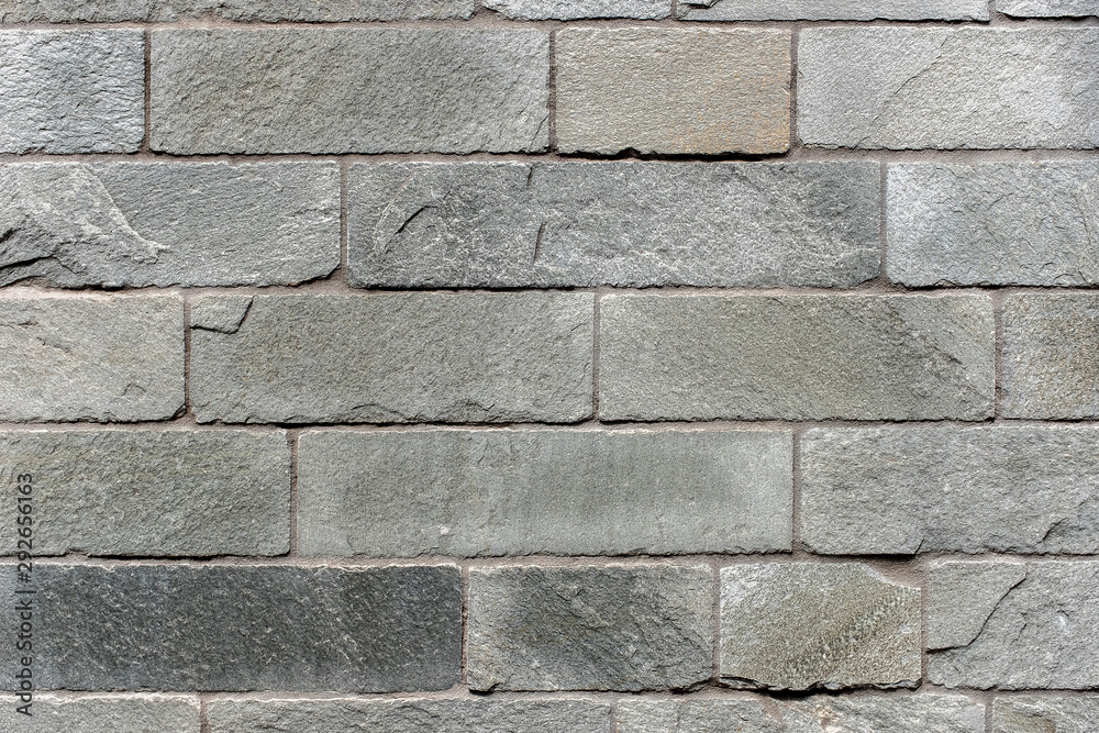Fototapeta premium Closed up grey brick wall texture. Architectural material construction.