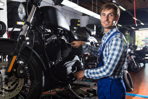 young male mechanic working in auto repair shop © caftor