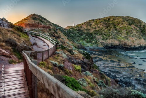 Wooden walkway lead toward Cape Schank Lighthouse on the Mornington Peninsula at sunset
