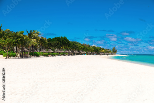 Tropical scenery - beautiful beach with blue ocean and sky
