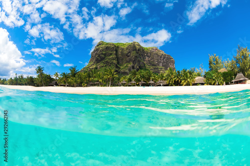 Tropical ocean with Le Morne mountain and white sand beach in Mauritius.