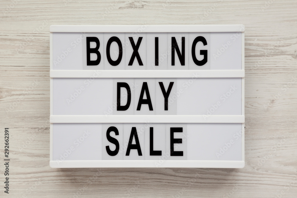 'Boxing day sale' words on a modern board on a white wooden surface, top view. Overhead, from above, flat lay. 'Boxing day sale' words on a modern board on a white wooden surface, top view. Overhead, from above, flat lay.