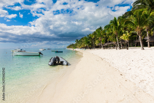 Beautiful view of the luxury beach in Mauritius. Transparent ocean  white sand beach  palms and sky