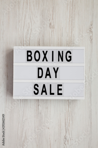 'Boxing day sale' words on a modern board on a white wooden background, top view. Overhead, from above, flat lay.