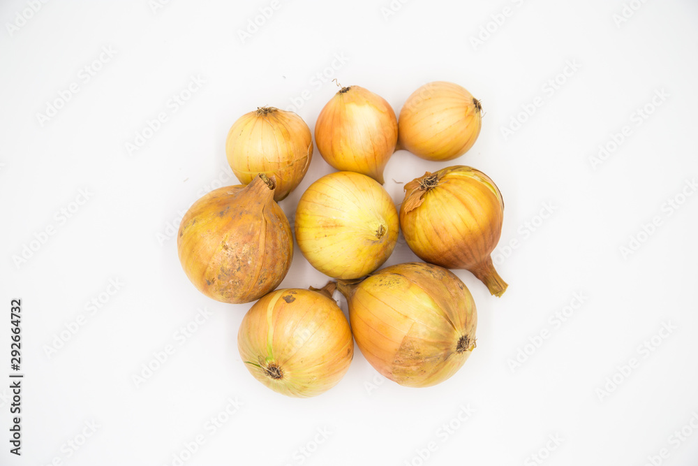 Yellow winter onions with peel and skin on white background. Yellow winter onions with peel and skin on white background.