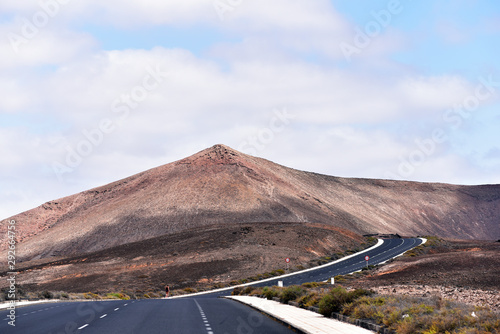Scenic road and volcanic landscape in Timanfaya National Park. Lanzarote, Canary Islands. Spain