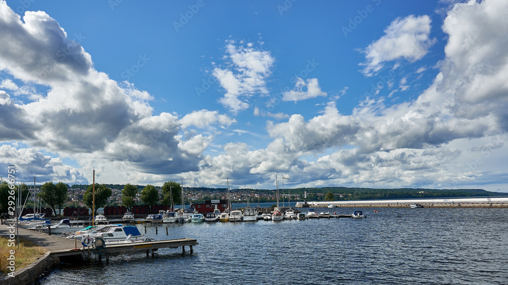Boats in harbor under clouds 