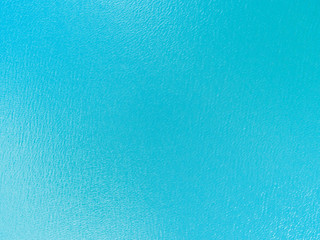 Aerial view of a Crystal clear sea water texture. View from above Natural blue background. Turquoise ripple water reflection in tropical beach. Blue ocean wave. Summer sea. Drone. Top view