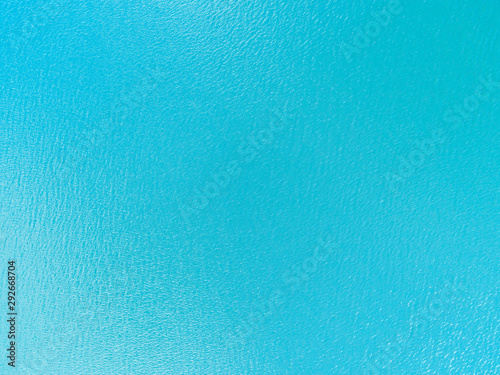 Aerial view of a Crystal clear sea water texture. View from above Natural blue background. Turquoise ripple water reflection in tropical beach. Blue ocean wave. Summer sea. Drone. Top view