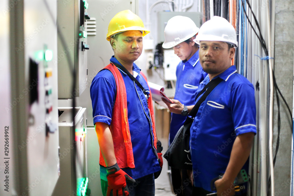 construction electricians with technician asian man installing meter. yogyakarta indonesia. august 06, 2019 construction electricians with technician asian man installing meter. yogyakarta indonesia. august 06, 2019