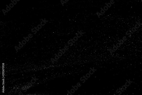 abstract real dust floating over black background for overlay photo