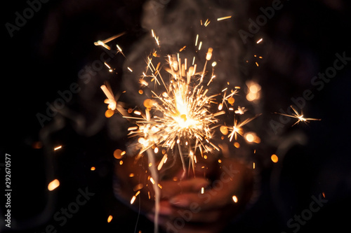 Female Hand Holding A Beautiful Burning Sparkler At Night
