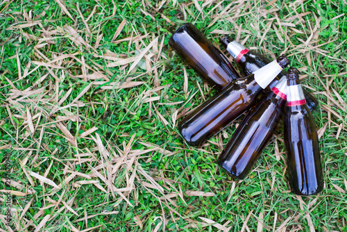 Glass bottles piled on the lawn, Focus on bottle, Environmental concept. Close-up.