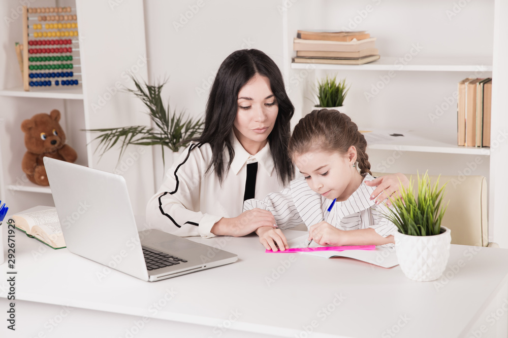 Home education concept. Tutor and girl doing homework together Home education concept. Tutor and girl doing homework together