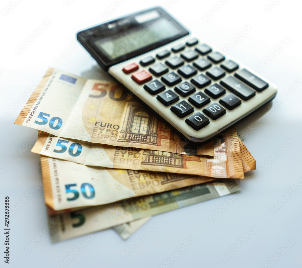 Banknotes and Calculator, Euro Banknotes on White Background Banknotes and Calculator, Euro Banknotes on White Background