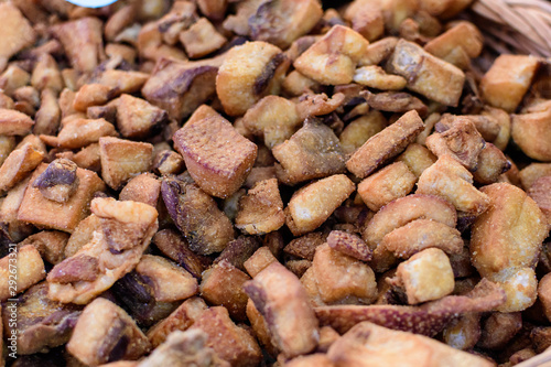 Close up of fried pork chops in display for sale at a street food market, selective focus