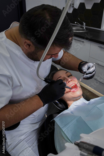 Dentist performs a dental examination of a pregnant patient