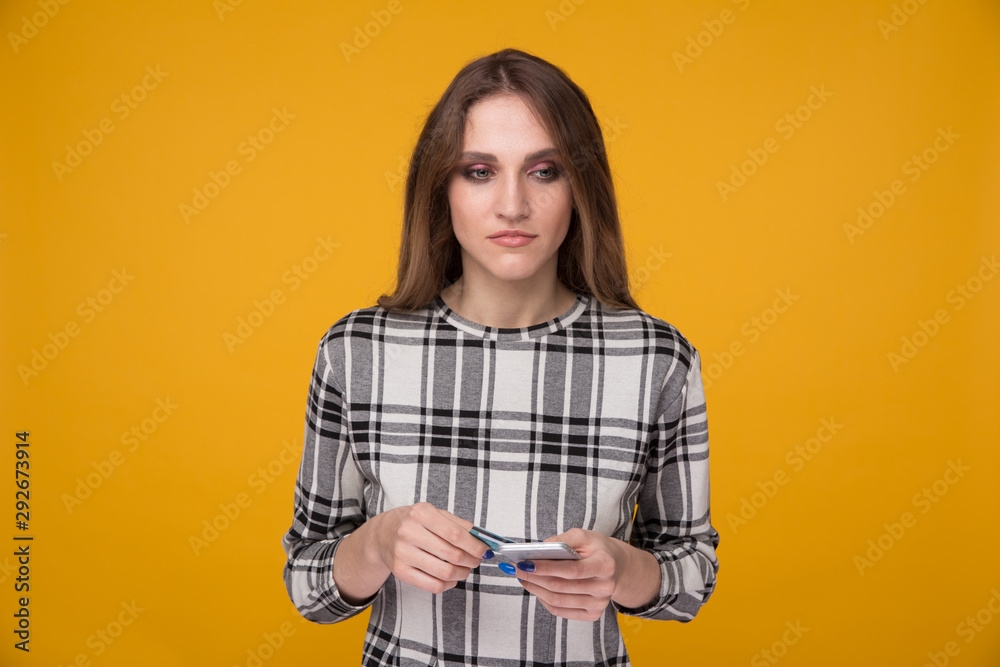 Woman with phone and credit card in the studio Woman with phone and credit card in the studio