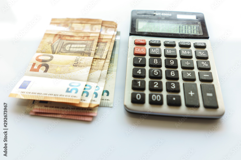 Banknotes and Calculator, Euro Banknotes on White Background Banknotes and Calculator, Euro Banknotes on White Background
