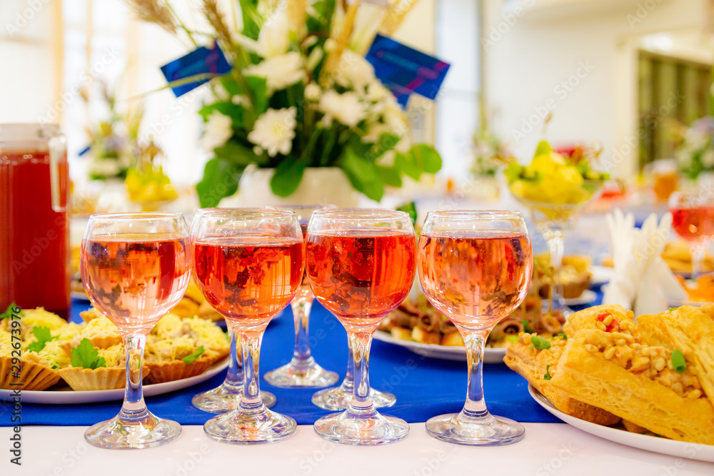 Rose wine in glasses on the Banquet table. Delicacies and snacks at the buffet. Catering.