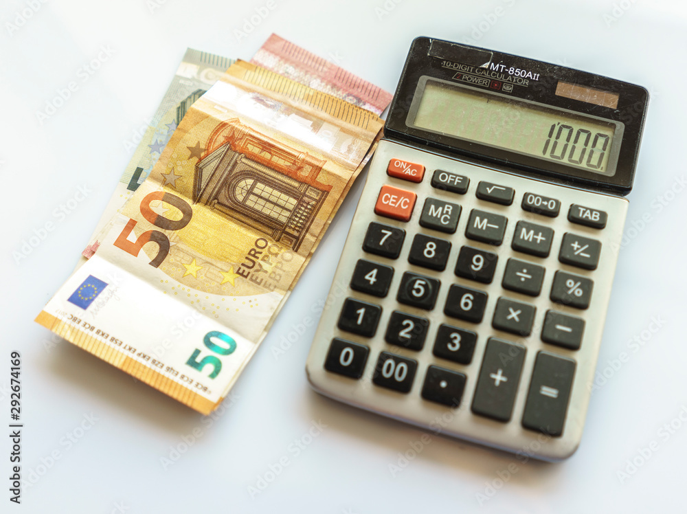 Banknotes and Calculator, Euro Banknotes on White Background Banknotes and Calculator, Euro Banknotes on White Background