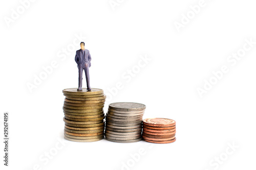 Miniature figures businessman on coins, on the white backgroud.