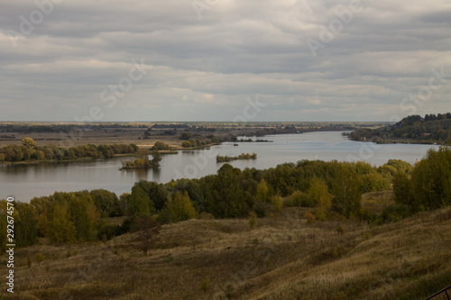 Autumn panoramic landscape with river and hills cloudy day in Konstantinovo village Russia © Inna