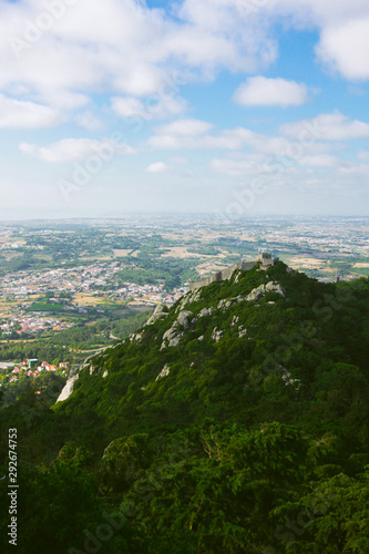 Cloudy view on the hill and portuguese town with green landscape