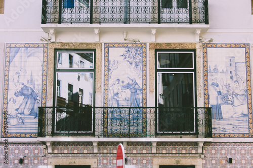 Typical portuguese antique tiles with windows and balcony