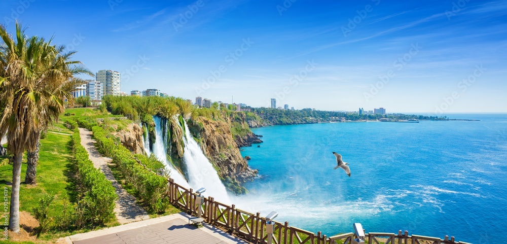 Aerial panoramic image of Lower Duden waterfall in Antalya, Turkey. Water falls drop off rocky cliff directly into Mediterranean sea in sunny summer day. - obrazy, fototapety, plakaty 