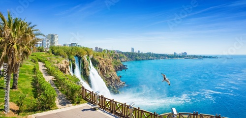Aerial panoramic image of Lower Duden waterfall in Antalya, Turkey. Water falls drop off rocky cliff directly into Mediterranean sea in sunny summer day. © IgorZh