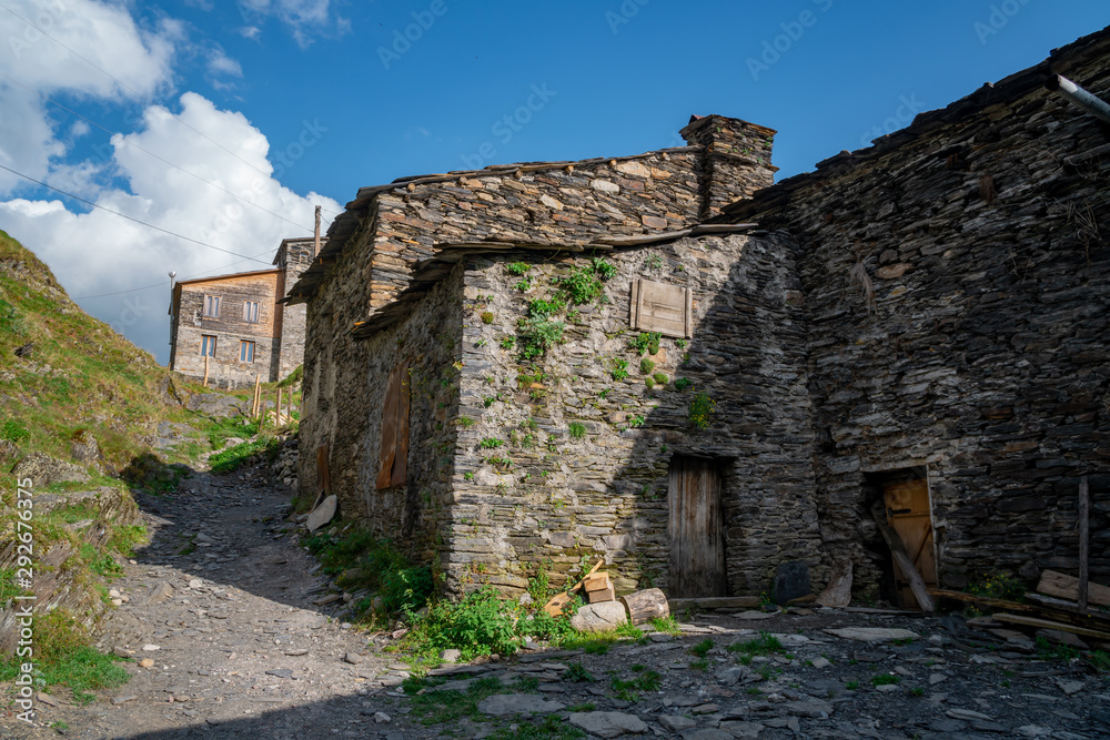 Typical old stone house with wooden door in Ushguli, Georgia. Traditional architecture of Ushguli. Typical old stone house with wooden door in Ushguli, Georgia. Traditional architecture of Ushguli.