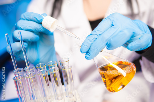 The hands of the chemist in...