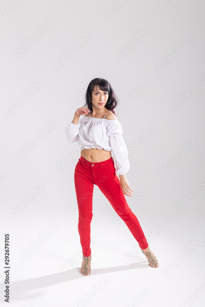 Latino dance, Improvisation, contemporary and vogue dance concept - young beautiful woman dancing on white studio background Latino dance, Improvisation, contemporary and vogue dance concept - young beautiful woman dancing on white studio background