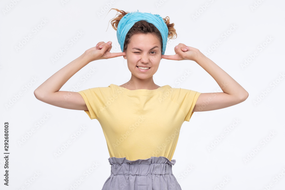 woman plugging ears, pretending not to hear what she is told. woman plugging ears, pretending not to hear what she is told.